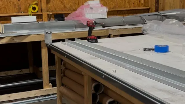 Installer assembling the bottom bar of a fire curtain system
