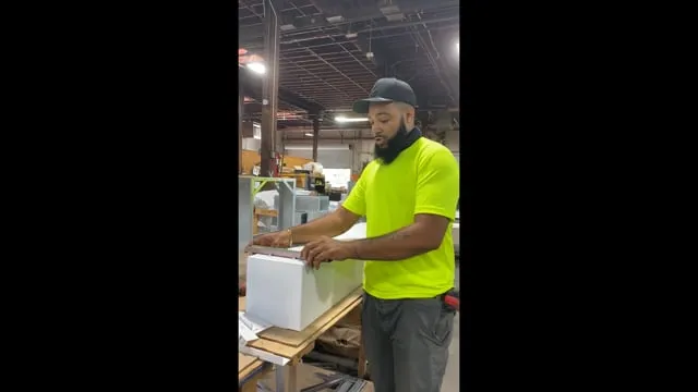 Installer demonstrating Kingdorf assembly on a workbench in the U.S. Smoke & Fire shop