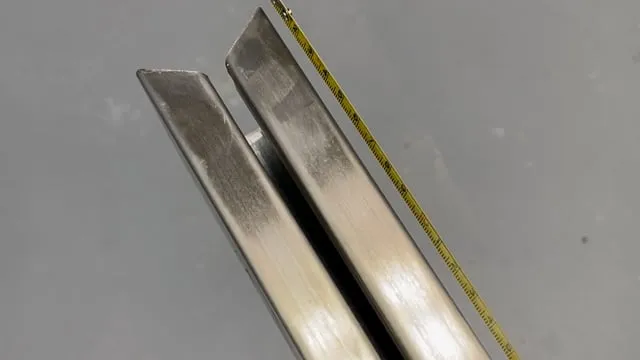 Installer fitting a side guide rail for a fire curtain system